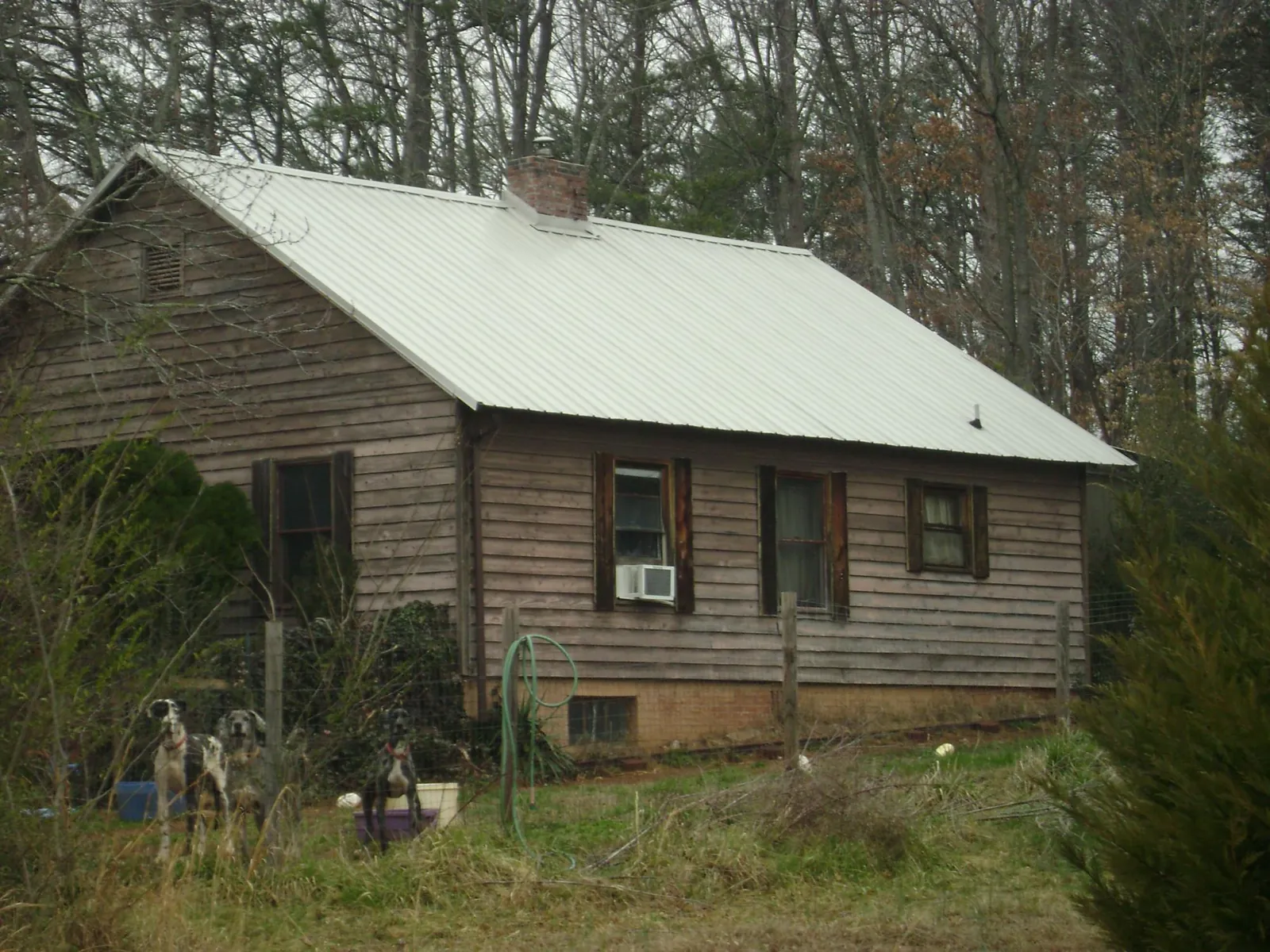 White metal roof on an old wood sided farmhouse, from a Asphalt Shingle Roof Repair job in West Point